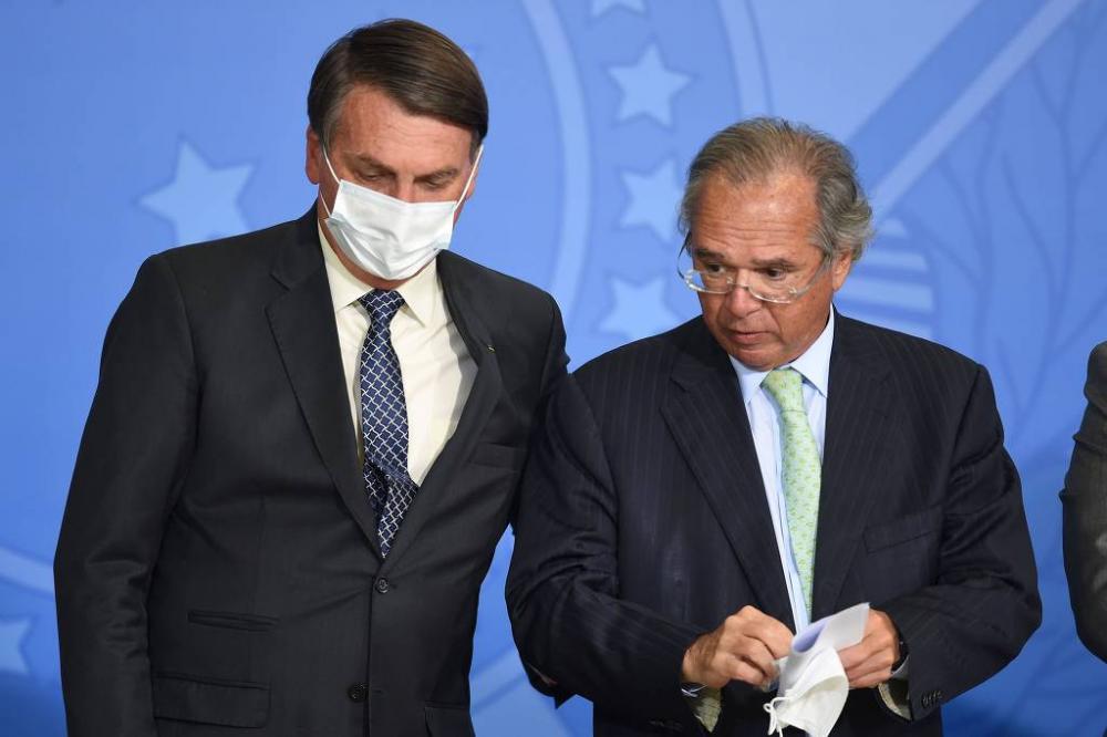 Jair Bolsonaro e Paulo Guedes (Economia) durante cerimônia no Palácio do Planalto - Evaristo Sá/AFP